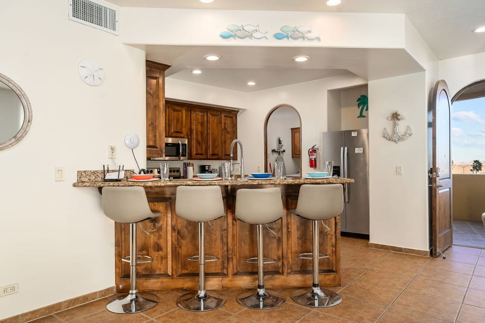 Breakfast bar seating for four, perfect for casual meals, cocktails, or keeping the chef company