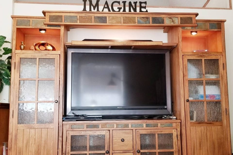 Huge Slate Tile Inset Entertainment Center with accent lights paired to Smarthome System. Includes Large LCD TV w/ Roku SmartTV options. Enjoy my HULU, Netflixs, & Sirius Apps. *Will replace with staged photos once the we finish remodeling the home. 