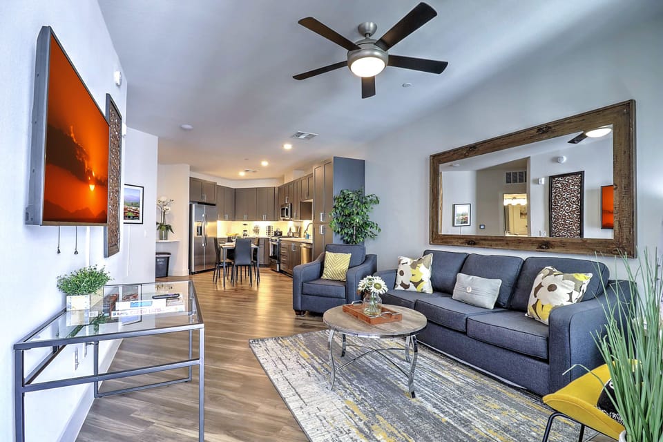 Relax in the cozy living room featuring plush seating, tasteful décor, and a smart TV for your entertainment.