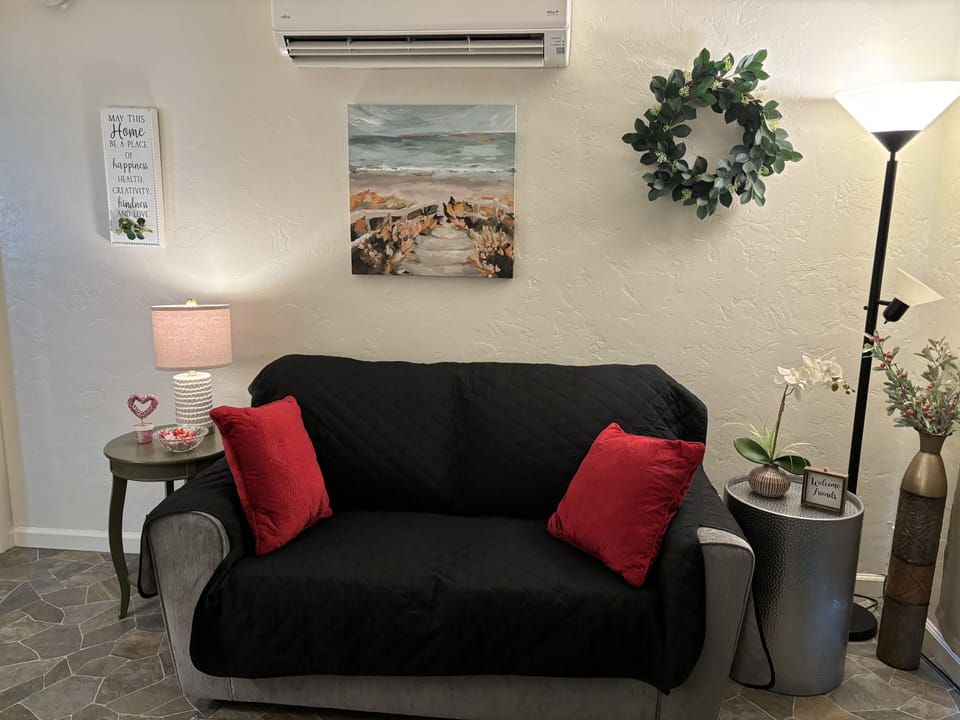 Comfortable loveseat with sanitized sofa cover. 