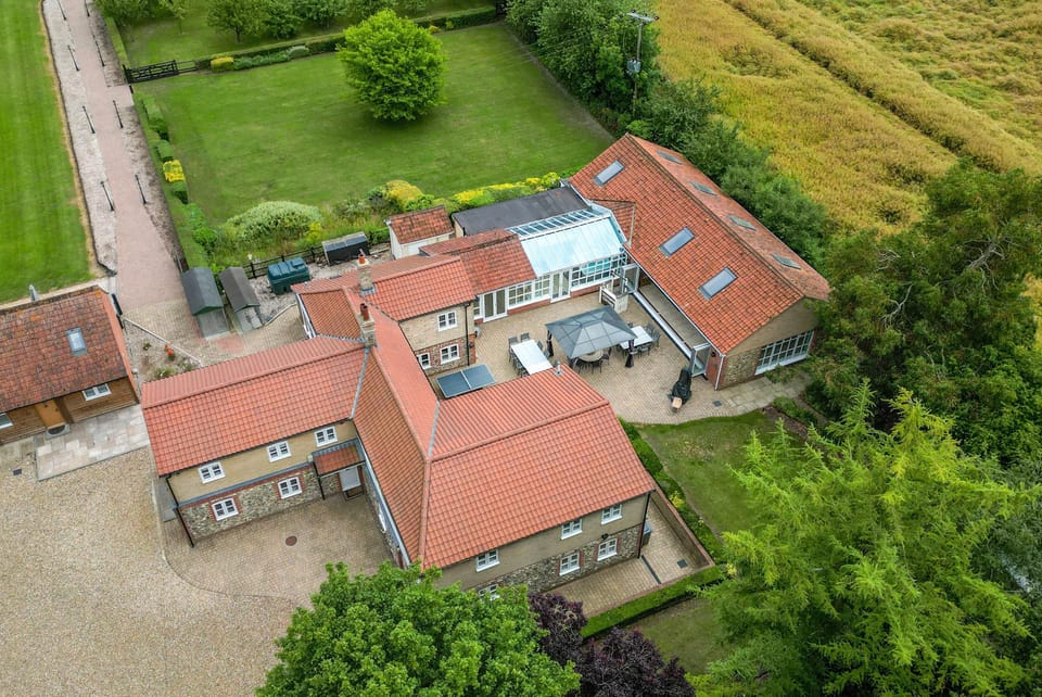 The cottage features a private swimming pool, indulgent sauna, and a relaxing hot tub for the ultimate getaway.