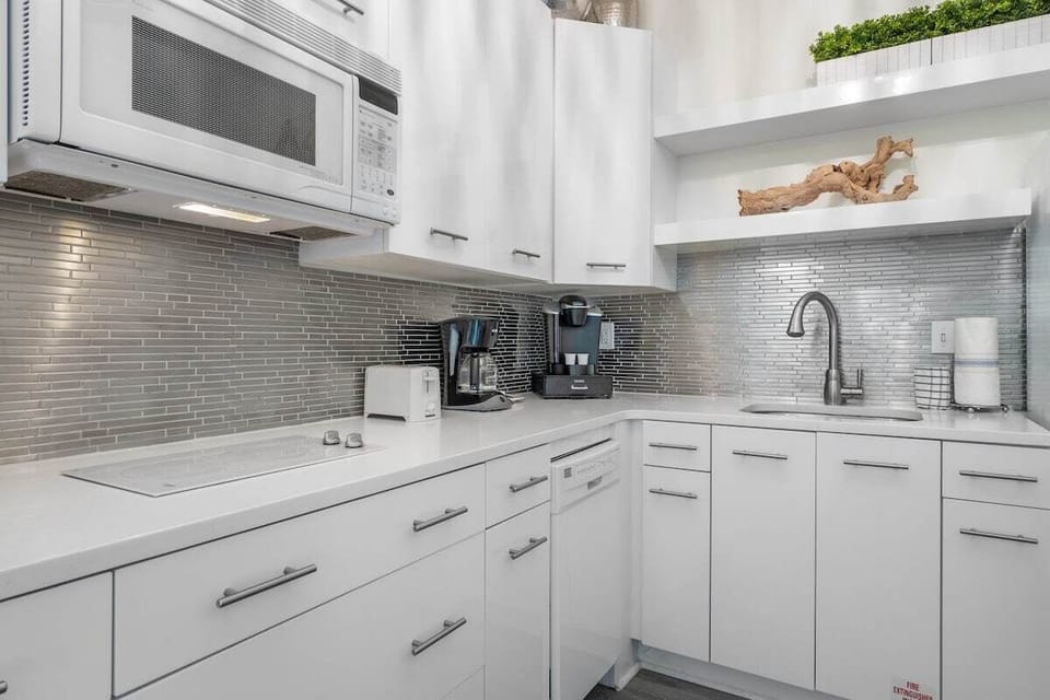 The kitchenette is equipped with granite countertops, a coffee maker, microwave and refrigerator.