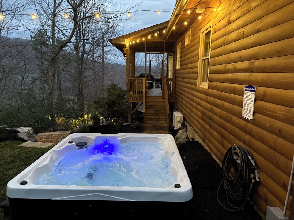 Soak under the stars in your private hot tub, surrounded by trees.