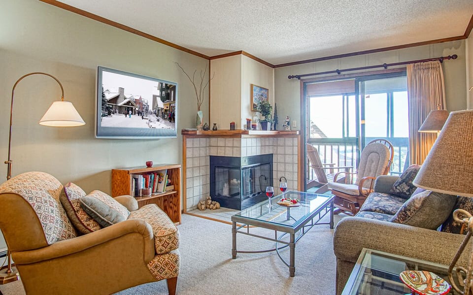 Living room with electric fire place and queen sleeper sofa
