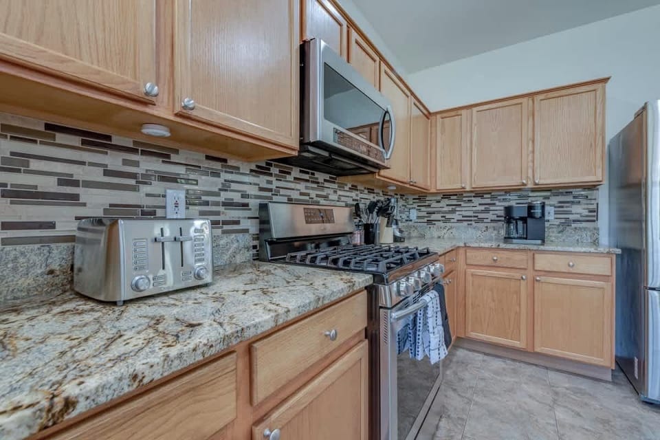 The kitchen boasts many modern cooking appliances.