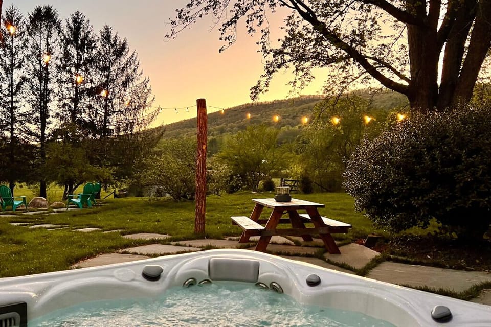 Six person hot tub overlooking backyard valley sunsets