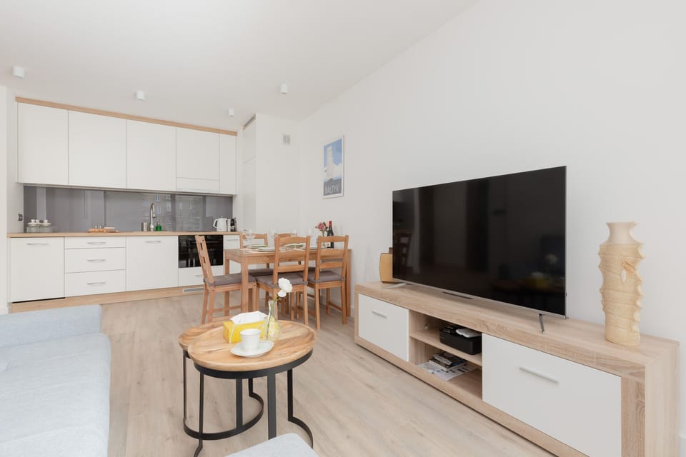 The main living area with an open floor plan, showing the dining table, kitchen, and living space all in one cohesive area.