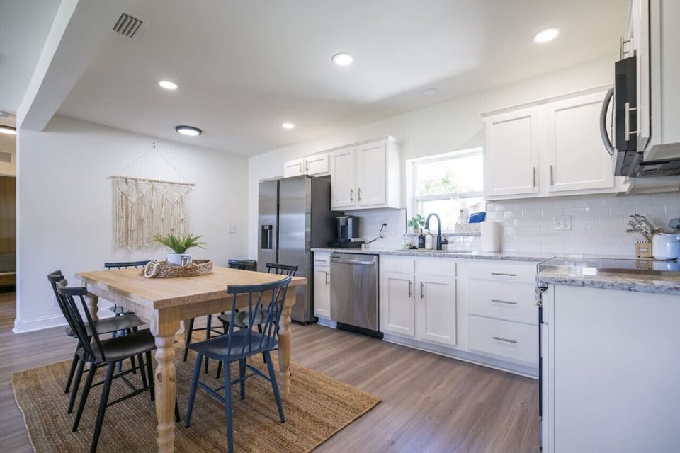 Cook and dine with ease in this open kitchen featuring new appliances, a fully stocked setup, and a K-Cup Keurig for your coffee fix.