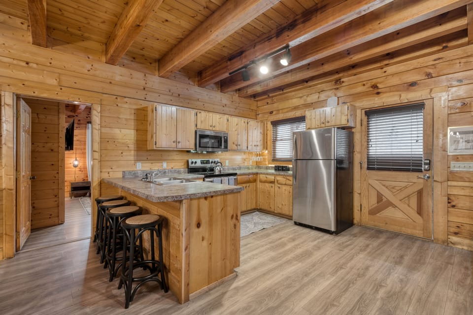 Spacious kitchen with barstool seating.