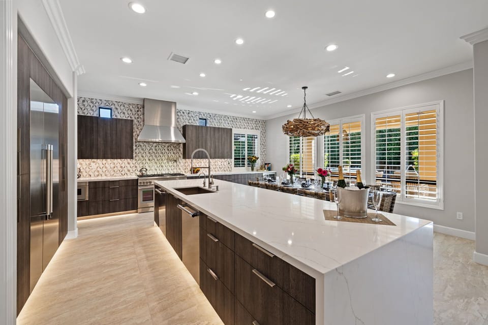 The kitchen is a chef's dream: Thermador refrigerator/freezer, gas range, double ovens, and two dishwashers make meal prep and clean-up a breeze.