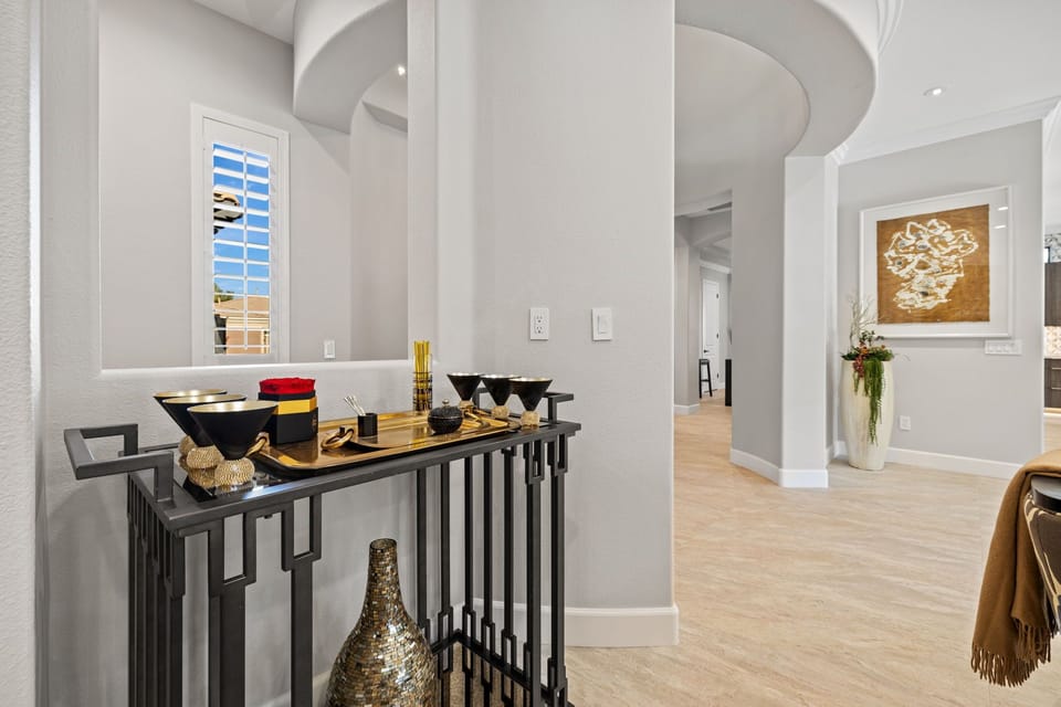 Dramatic foyer spilling out into kitchen, billiard room, and living room.
