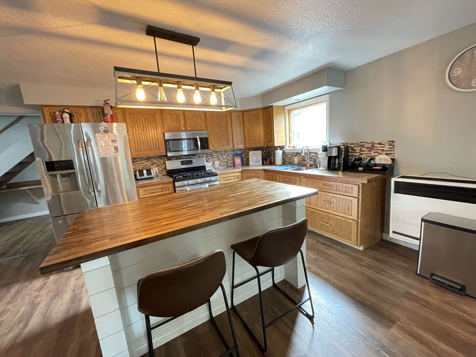 Kitchen with plenty of dishes, glasses, silverware, pots, pans and more! 
