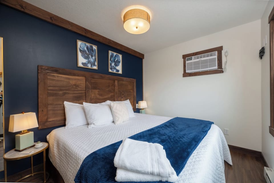 Recharge in this peaceful king bedroom, complete with plush bedding, warm lighting, and a private vanity—perfect for getting ready without waiting on the main bathroom.