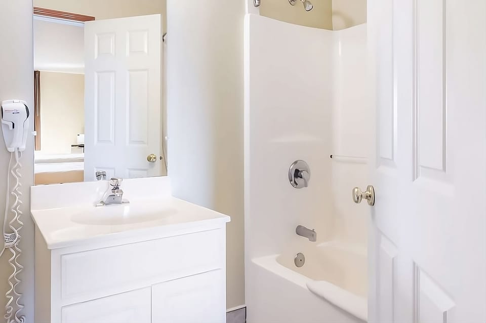 Bathroom with a shower and tub. The essential toiletries and towels are provided