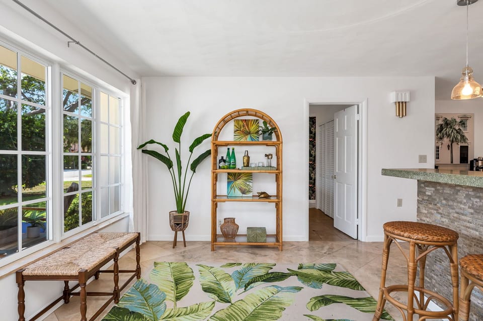 The home entrance is inviting and warm. There are tropical Palm Beach accents throughout and direct access to the bedrooms and the kitchen.