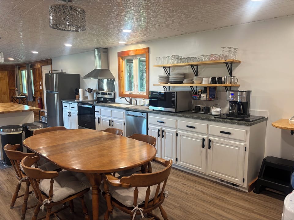 Kitchen with stainless steel appliances, microwave, coffee area 