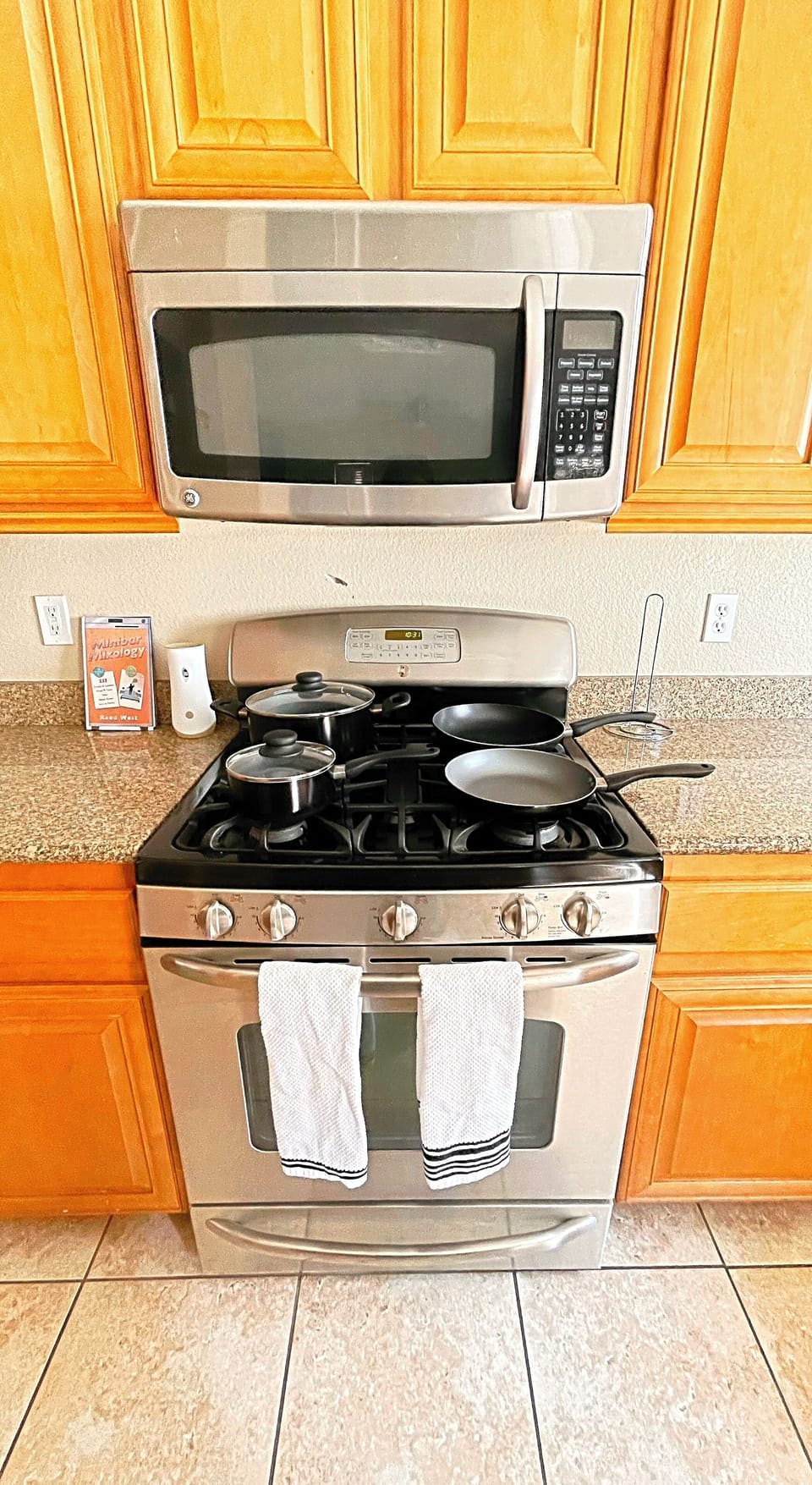 Stainless steel appliances, fully stocked kitchen.