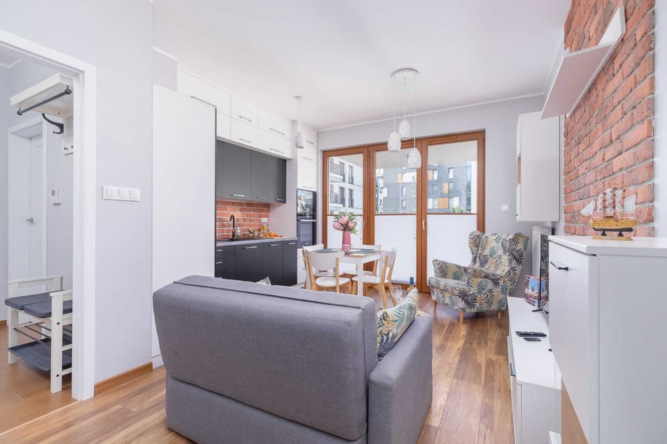 The living room leads out onto a balcony through which an abundance of natural light enters, which emphasises the unique character of the room.