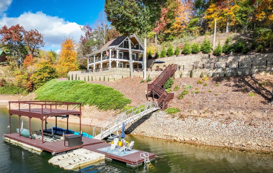 Fall at Skipping Stones Getaway Backyard with hot tub, fire pit, wood, roasting forks, corn hole boards, picnic table