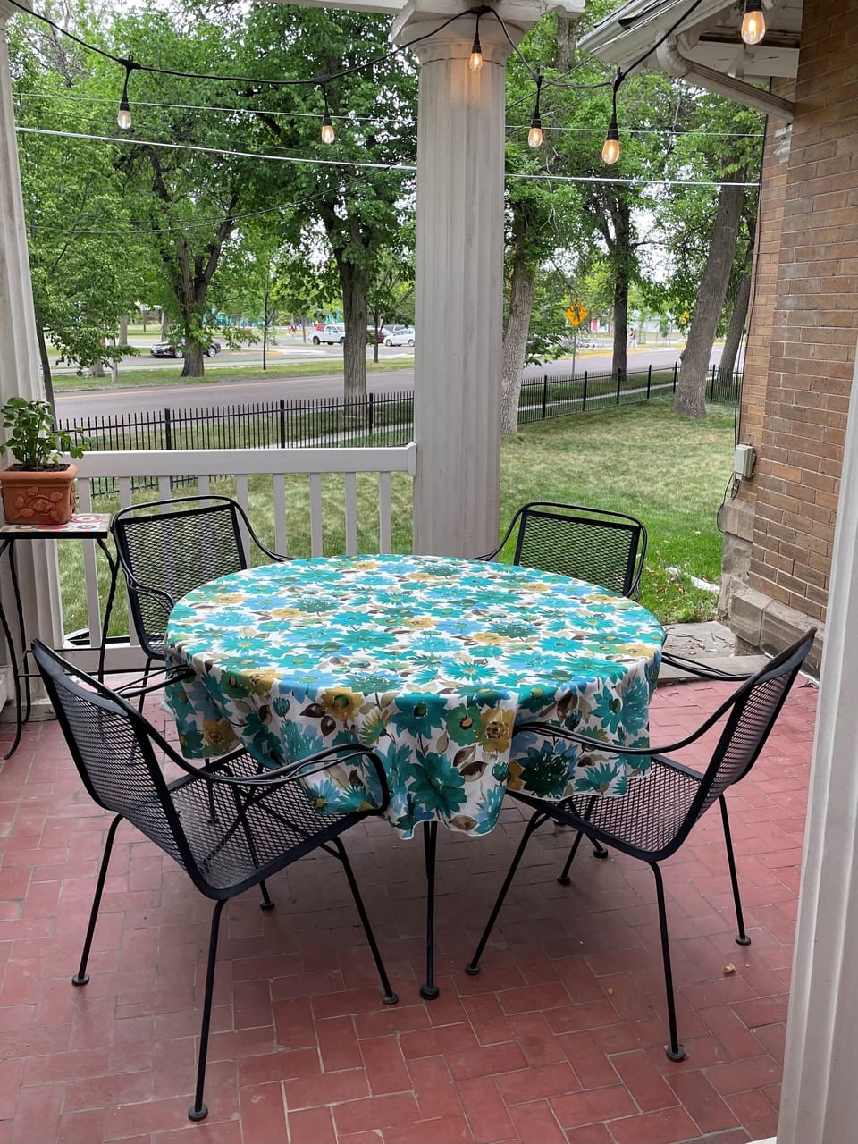 Back patio with view of the park and a table for dining. 