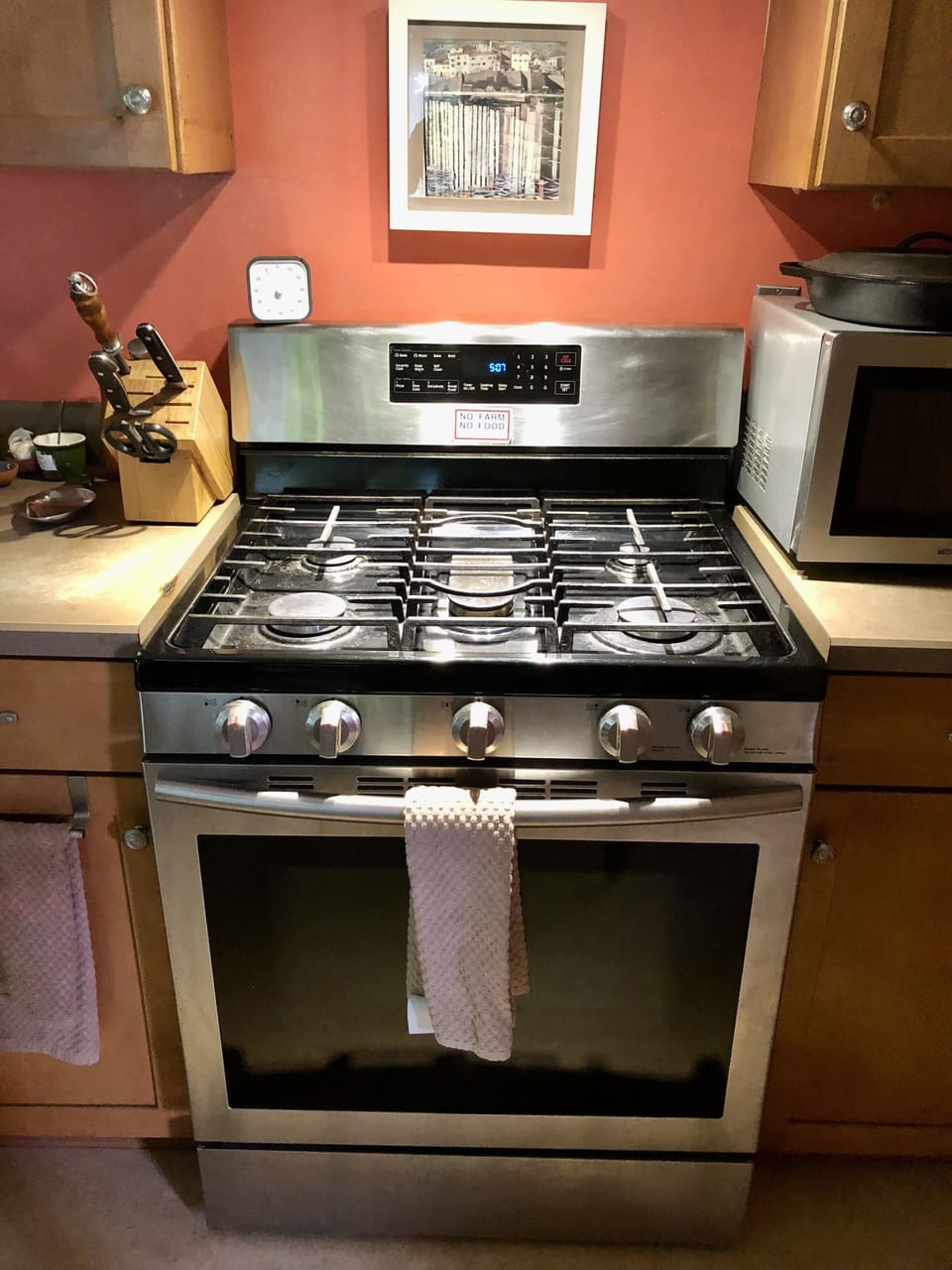 Gas stove. Microwave next to it.