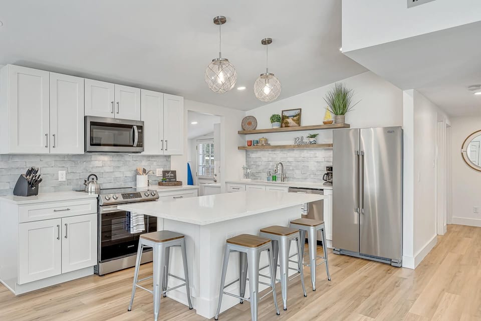 Stylish new kitchen with seating at the island and open to the living room. 