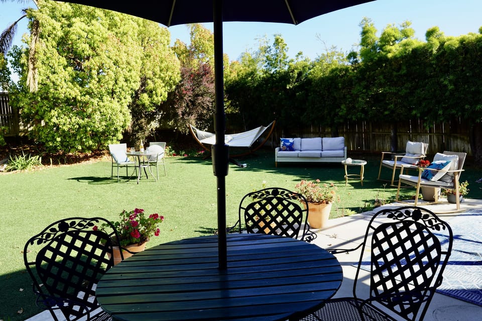 Enormous private fenced backyard with tropical foliage