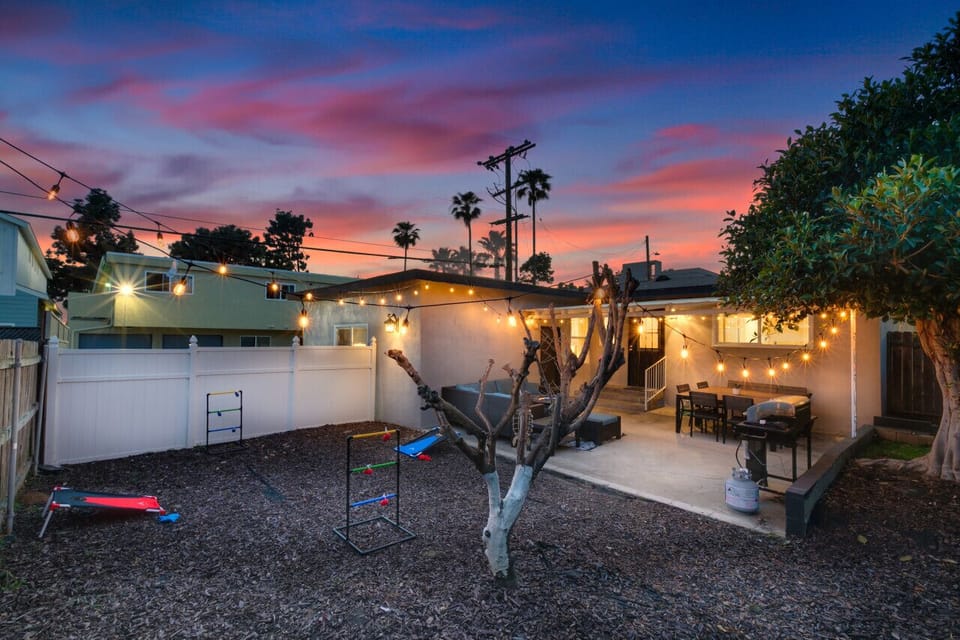 Backyard illuminated by string lights at night