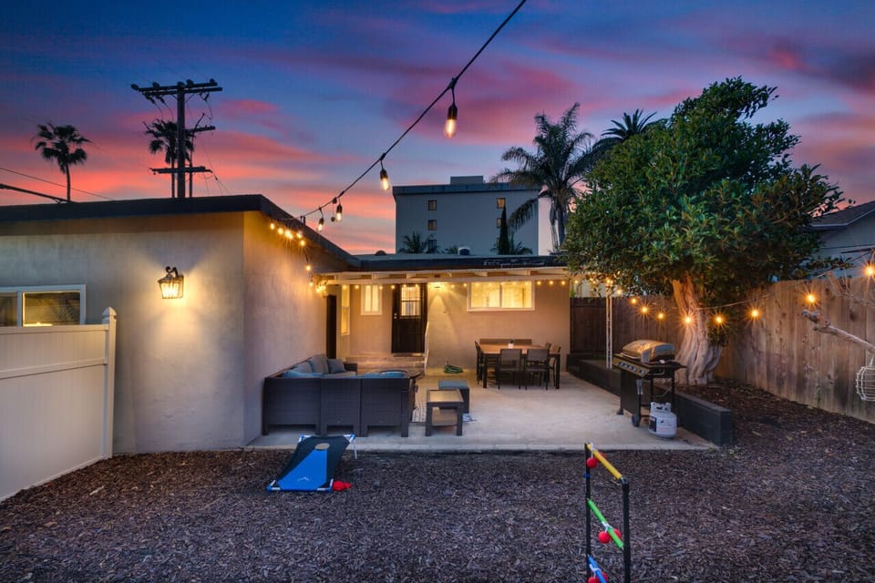 Backyard illuminated by string lights at night