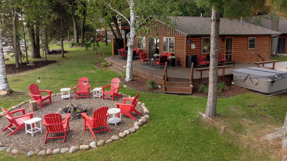 pacious Crosslake cabin with firepit circle, hot tub, deck, and room to gather!
