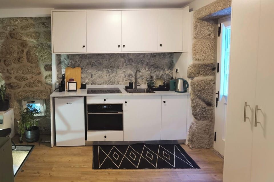 Fully equipped kitchen with Nespresso coffee maker, hot water kettle, refrigerator, integrated washing machine and combined microwave / oven