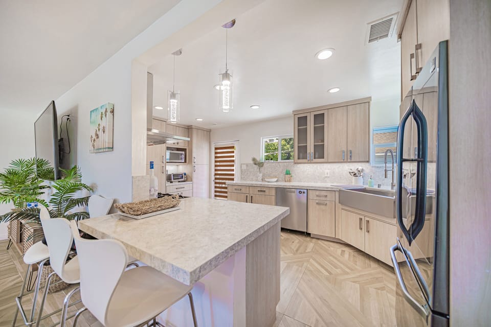 Countertop and Barstools connected to the kitchen.
