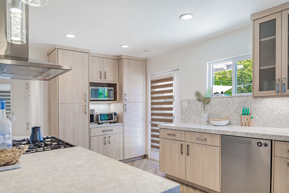 Kitchen with hood vent, dishwasher and Coffee Maker/Microwave Station.