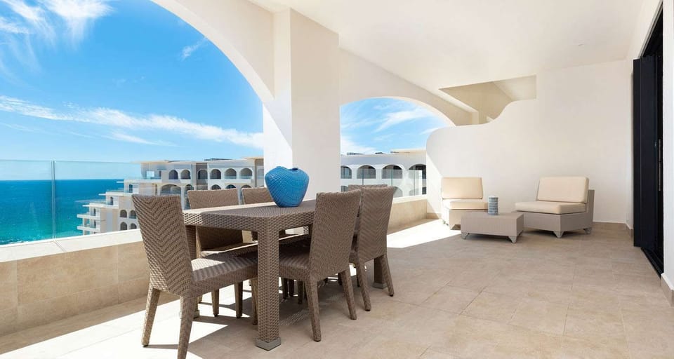 Patio with table and chairs and two lounge chairs