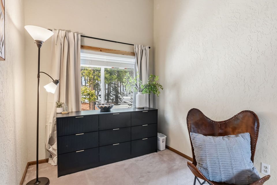 Relax in your vintage leather chair while natural light filters through, creating the perfect reading nook.