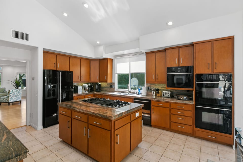 Fully Equipped Kitchen with Cooking Appliances and Serving Trays.