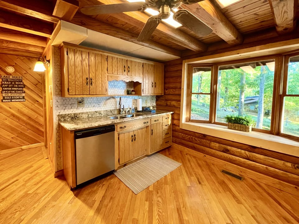 Additional view of kitchen with large bay window, looking out to the side yard.