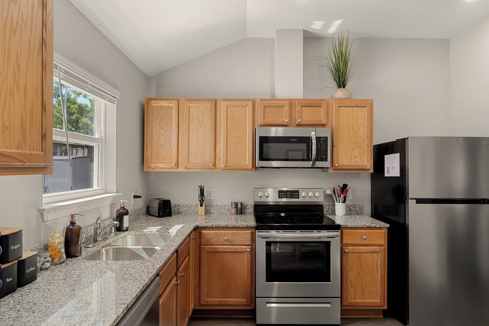 Kitchen with stainless appliances, granite counters, and everything needed for easy meals at home.