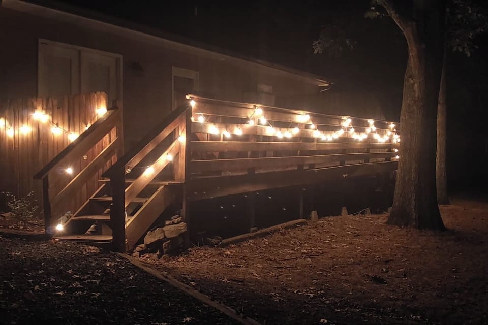 Private Escape outdoor deck with string lights and wooded views — Duggin Homes Mt. Juliet TN