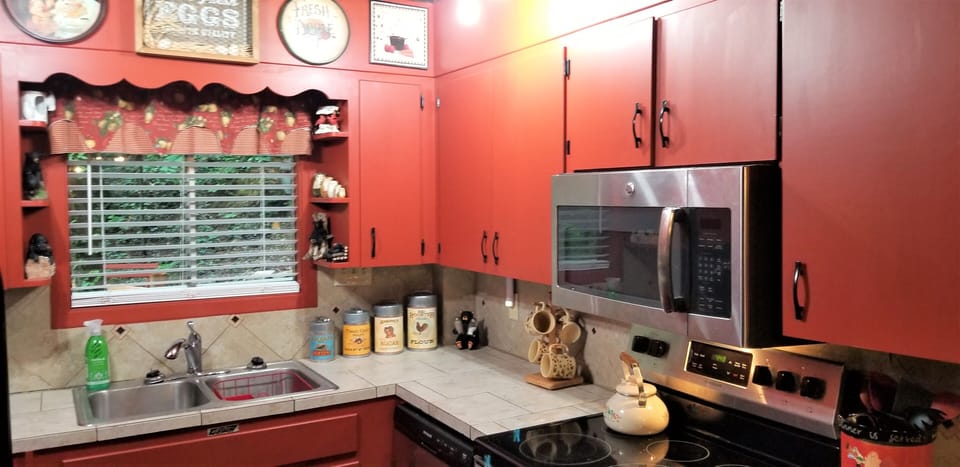 The kitchen has a microwave, refrigerator, smooth top range, and dishwasher
