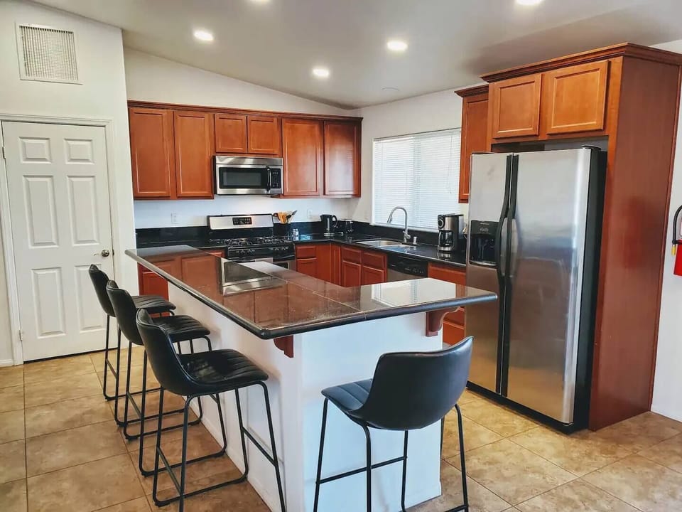 Fully Stocked Large Kitchen with Bar Stools
