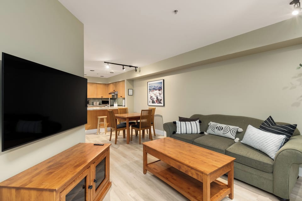 Open-concept living and dining area with Smart TV, fireplace, and seating