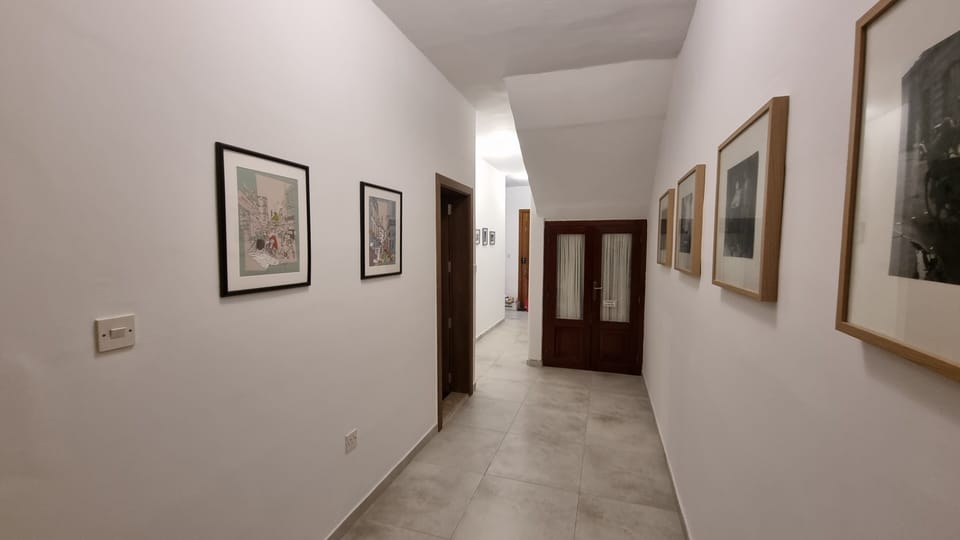 Spacious corridor leading from the front hallway to the bedrooms
