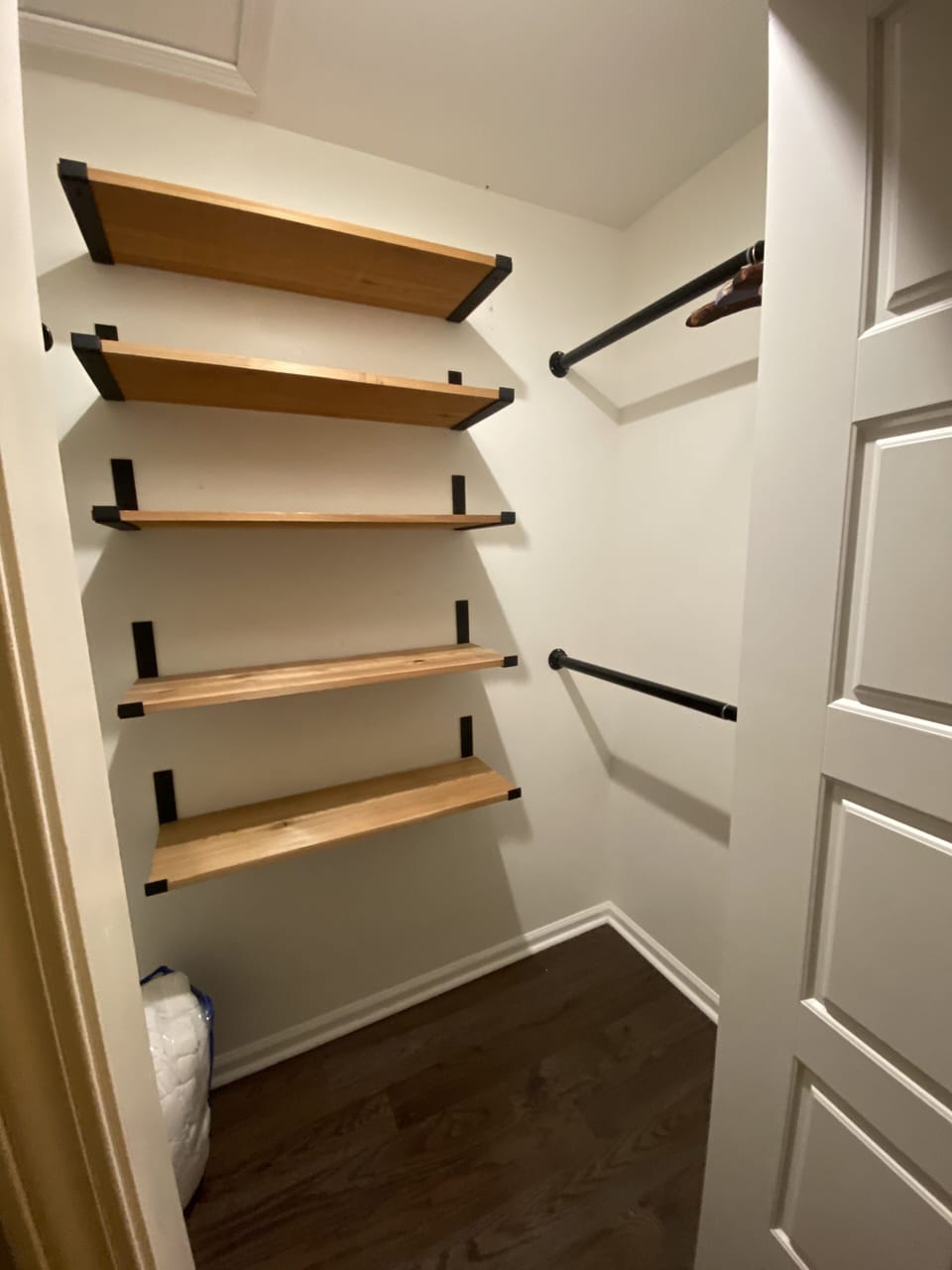 Master Closet with western cedar shelving. Hanging rods are on both sides