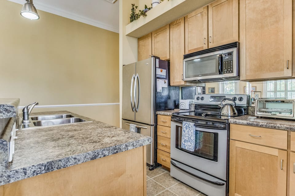 Savor the flavors of your favorite dishes in the fully-functional kitchen, boasting a smooth-top electric stove and over-the-range microwave hood for ultimate cooking convenience.