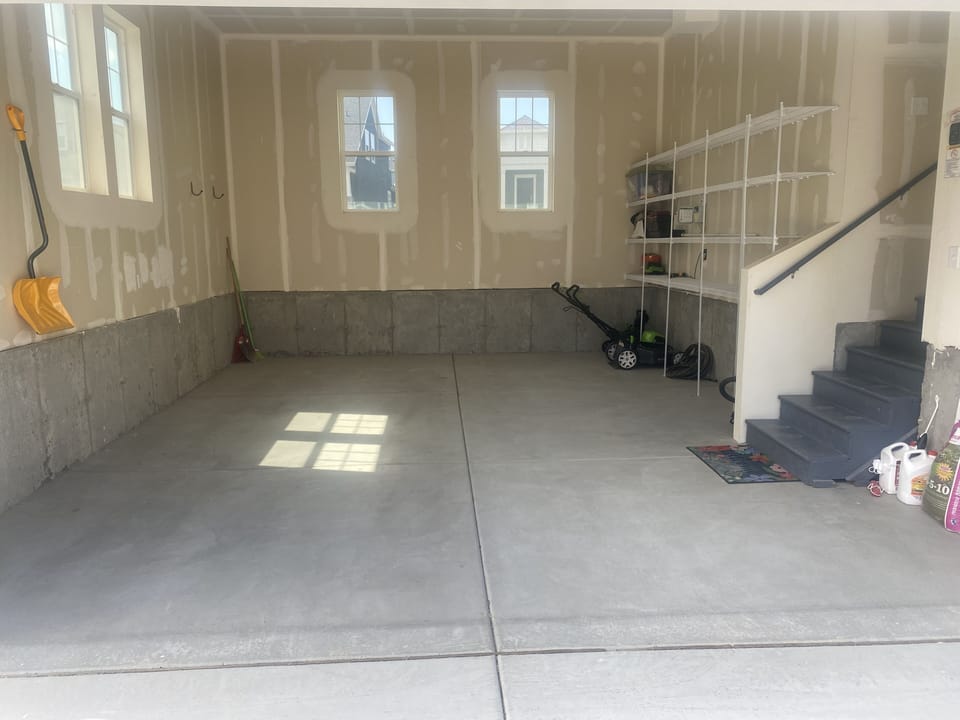 Large empty garage for parking cars or storage.