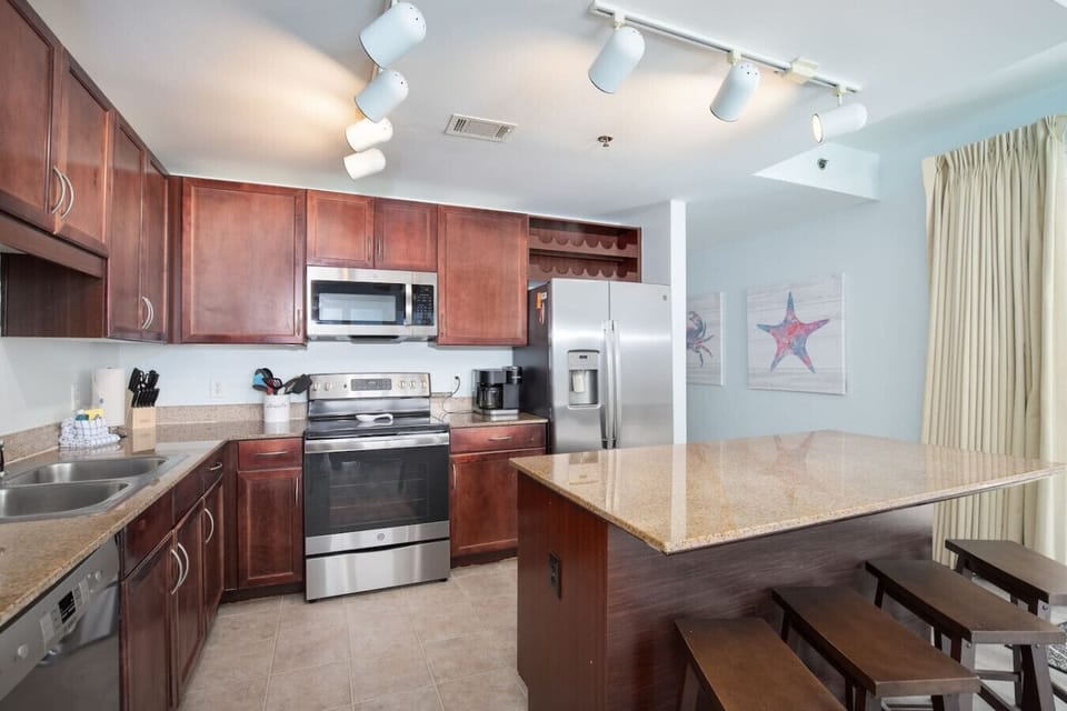 Fully Stocked Kitchen with Ocean Views, Island Bar Seating, Stainless Steel Appliances and Dual Coffee Machine