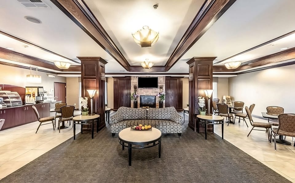Unwind in the inviting lobby with warm lighting and seating.
