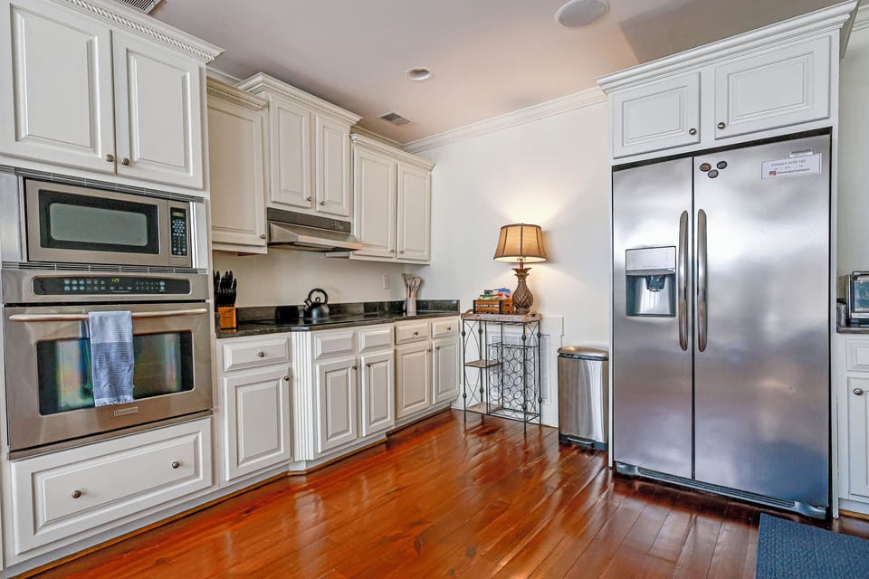 Kitchen area, complete w/ microwave, oven, cooktop, refrigerator, & dishwasher. 