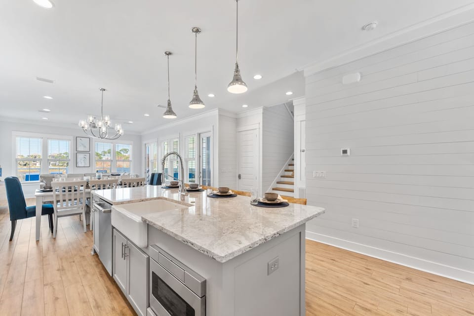 Your spacious kitchen flows seamlessly into the dining area, where natural light streams through windows as you prepare memorable meals on gleaming countertops.
